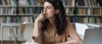 woman trying to make a decision at a desk